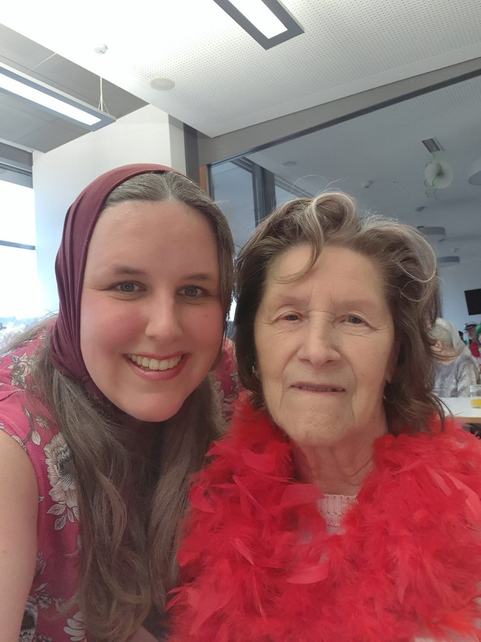 Unser Tagespflegegast Frau Fahrner hat für heute extra ihre knallrote Federboa ausgepackt.